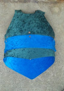 The chest plate, in four pieces, covered with velvet and riveted together.