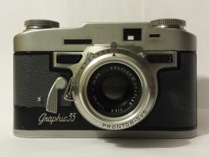 Graphic 35. The black buttons on either side of the lens are the focus.