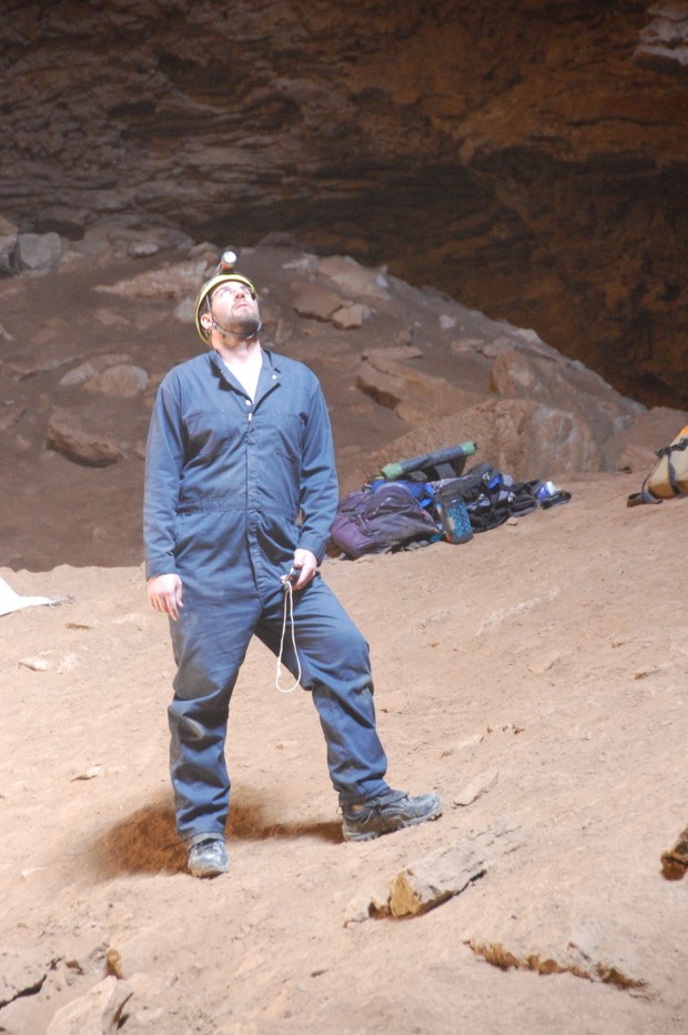 Postdoc Cory Redman watches while the top crew prepares to hoist up some sediments for screen washing.