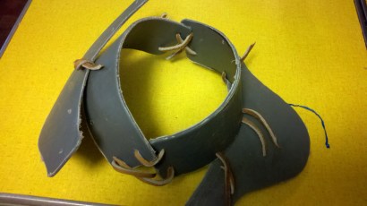 Gorget pieces tied together so that they are held in place during heating and molding.