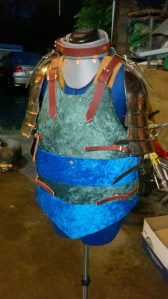 The finished body armor, strapped and hanging on my dress model. For fun, I hung a pair of metal pauldrons off the shoulders.